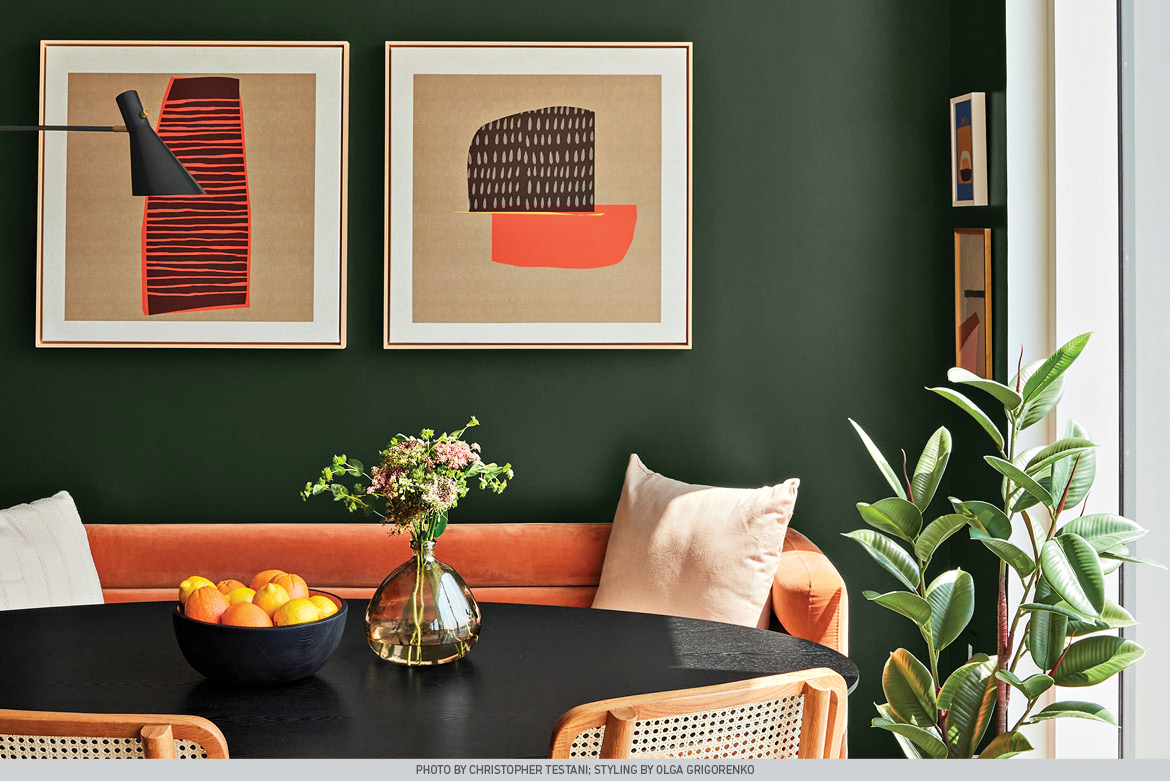 Deep, Aged Pine wall complements rust-hued sofa and cane-and-wicker dining table.