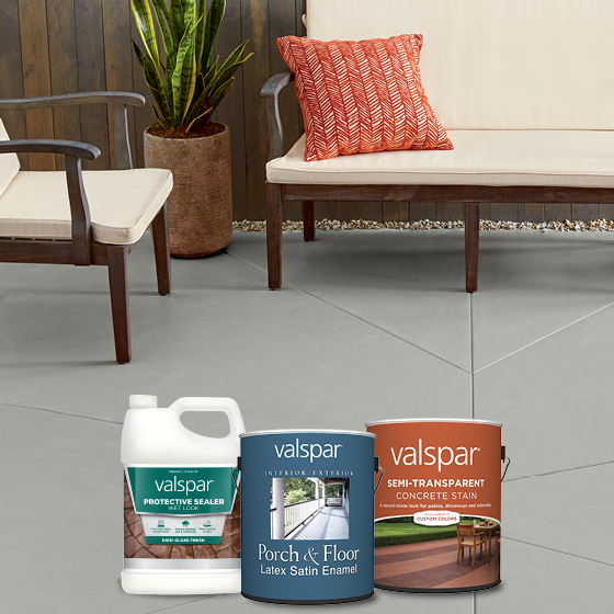 A gray cement patio, a modern outdoor couch and chair, plus Valspar protective sealer, porch, floor and concrete stain products.